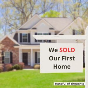 House with for sale sign reading "we SOLD our first home"